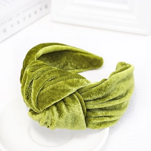 Macro detail of the green velvet fabric texture on this knotted wide-brim headband