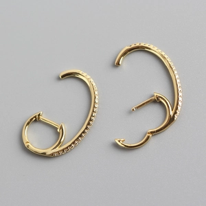 Detailed close-up of gold S925 sterling silver hoop earrings with sparkling crystal stones