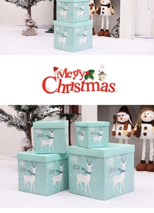 Set of four mint green Christmas gift boxes with reindeer motifs and festive typography