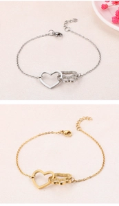 Detailed view of titanium steel bracelet featuring heart and pet paw print link charms