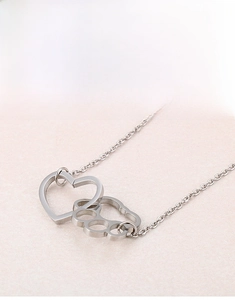 Polished stainless steel interlocking heart and cat paw pendant with delicate silver chain