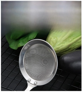 Detail view of 304 stainless steel fine mesh skimmer with reinforced long handle for cooking