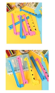 Detail of 15cm cartoon giraffe rulers in pink, yellow and blue with wave edge design