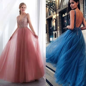 Detailed view of sequined evening dresses in mauve and royal blue with deep V-neck design