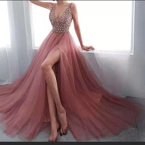 Detailed view of mauve evening gown featuring sequined bodice and flowing slit tulle skirt