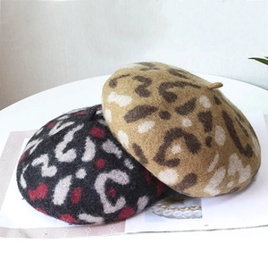 Detailed view of leopard print wool blend berets in grey and brown for autumn