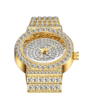 Luxury women's gold quartz watch with full crystal pavé details on a white background