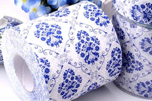Detailed view of printed toilet paper featuring classic blue floral porcelain patterns