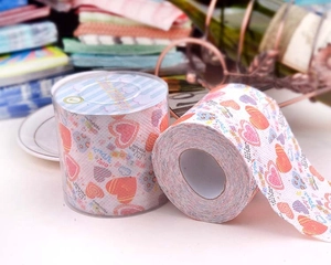 Detailed view of novelty toilet paper roll with colorful hearts and fun text prints