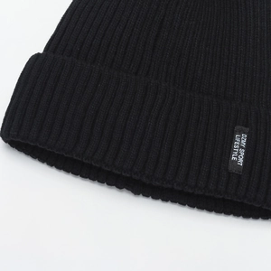 Classic black ribbed knit beanie with a woven sport lifestyle patch for winter warmth