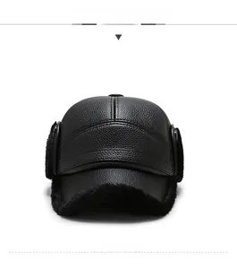 Close-up of black leather winter baseball cap featuring plush faux fur ear flaps for warmth