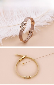 Detail of mesh strap heart bracelets in rose gold and gold finish with infinity symbol
