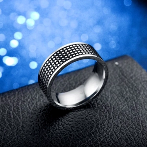 Retro titanium steel signet ring with checkerboard pattern on black textured stand