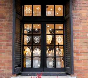 White snowflake window stickers applied on a glass pane for Christmas festive decoration