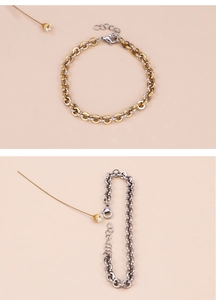 Detail of silver and two-tone gold round link chain bracelets with lobster clasps