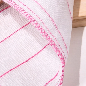 Absorbent white mesh dishcloth with pink stitched edges for household cleaning tasks