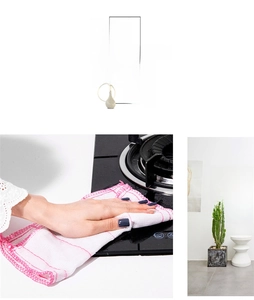 Detail display of pink checkered absorbent cleaning cloth wiping a kitchen stove top