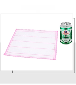 Close-up of white mesh dishcloth with pink stitched edges next to a size reference