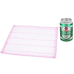 Absorbent multi-layer cotton gauze dishcloth with pink stitched edges next to soda can