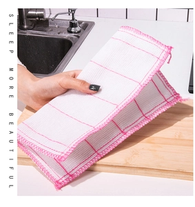 Close-up of a white and pink checkered cotton dishcloth in a modern kitchen setting
