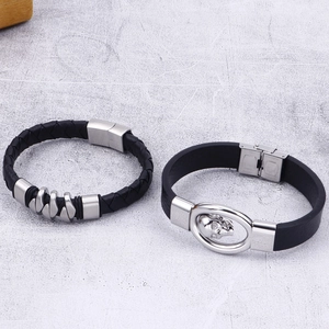 Men's black leather braided bracelet set featuring a silver skull charm and metal clasp