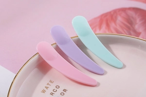 Pink, purple and mint green plastic cosmetic spatulas for cream application and mixing