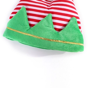 Detail of velvet Christmas elf hat showing red white stripes and green zigzag hemline