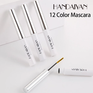 Macro shot of colorful mascara with yellow brush head and waterproof liquid bottles