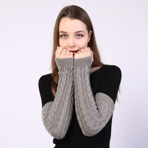 Detail showing grey and black cable knit wool arm warmers with soft textured twist pattern