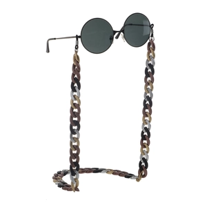 Detail view of large acrylic link chain for eyewear in gold, brown, and grey color mix