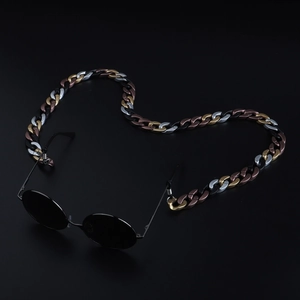 Detail of acrylic candy colored eyewear chain with oversized gold and silver links