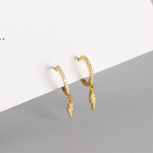 Detail of gold lightning bolt hoop earrings with sparkling cubic zirconia on a minimalist card
