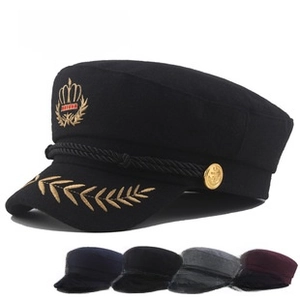 Detail of nautical flat top hat with gold embroidery and twisted rope decoration