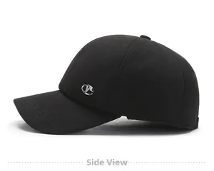 Close-up side view of a black winter baseball cap featuring a premium metallic logo detail