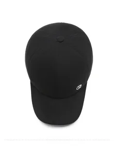 Overhead macro view of a black cotton winter baseball cap with a silver metal side logo