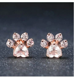 Detail of rose gold cat paw earrings with heart shaped stone and zircon accents