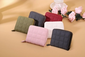 Quilted mini wallets in multiple colors with floral accents and zippered design