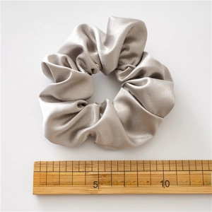 Champagne crystal satin scrunchie shown with a ruler for size measurement
