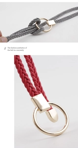 Detail of woven rope belts in grey and red with elegant gold metal ring buckles
