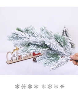 Close-up of realistic cedar branches with artificial snow for Christmas table decoration