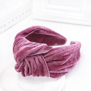 Close-up of knotted velvet headband in deep purple showing premium soft texture