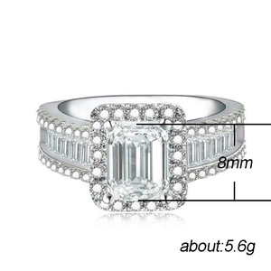 Luxury silver ring featuring a large emerald cut cubic zirconia with halo diamonds