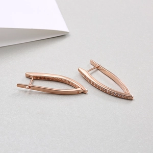 Macro detail of rose gold V-shaped earrings with micro-pave cubic zirconia stones