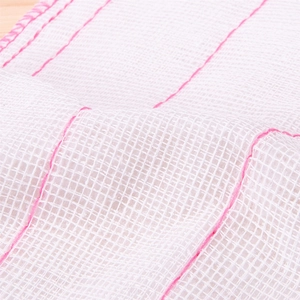 Absorbent white cotton mesh dishcloth with reinforced pink stitching for kitchen cleaning