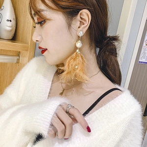 Bohemian long feather tassel earrings with pearls and rhinestones shown on model