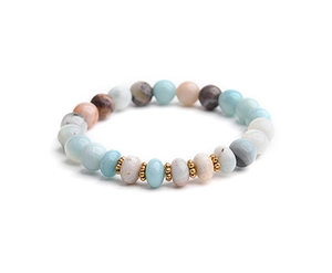 Macro shot of colorful natural stone beaded bracelet with gold metallic spacers