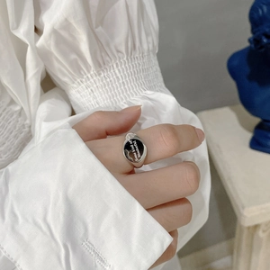 925 sterling silver ring with black oval face and white text engraving on model hand