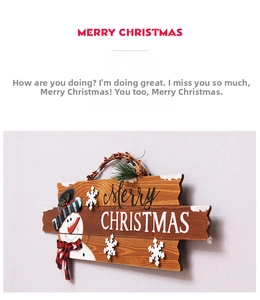 Detail of wooden Merry Christmas hanging sign featuring a snowman and snowflake accents