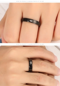 Détail d'une bague en acier titane noir avec une couronne argentée gravée pour couples