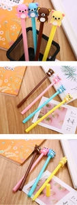 Detailed close-up of four colorful Rilakkuma cartoon pens in a stylish desk setup